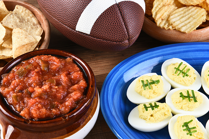 Closeup of snacks for watching a football game, chips, salsa and