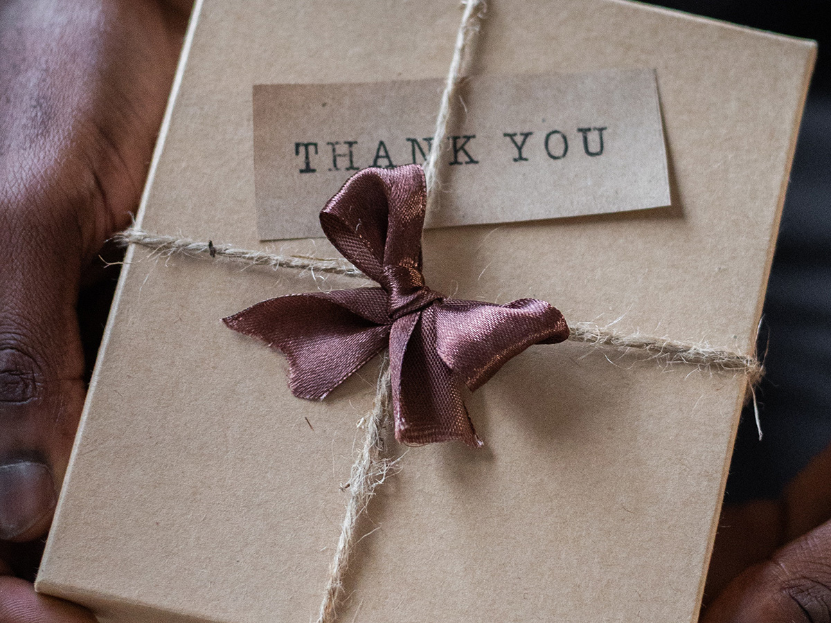 Image of a beautifully wrapped card with a ribbon in the middle