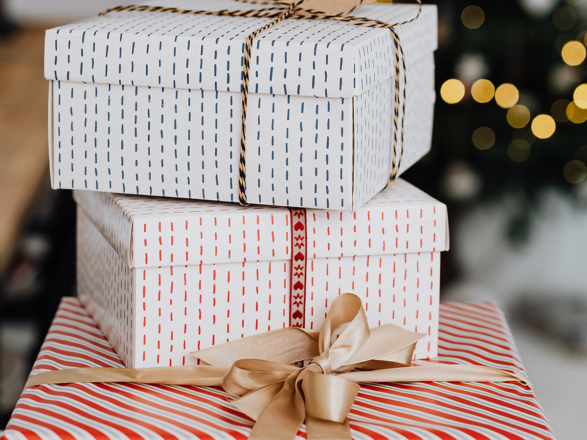 Image of nicely wrapped presents covered in Christmas Paper