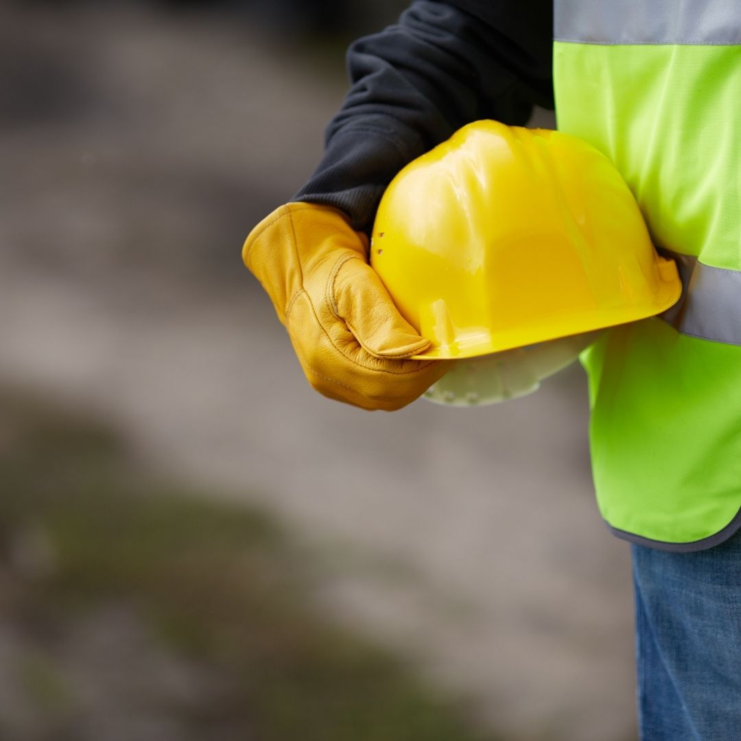 construction worker holding hardhat