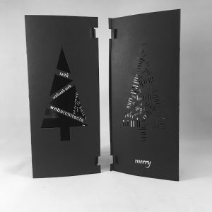WNB Architects' tri-folded Holiday Cards that are foil stamped, laser cut, and printed on black paper with white toner. 
