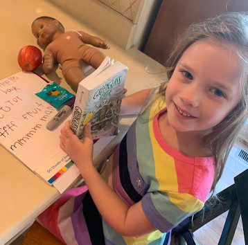 Girl reading book at table