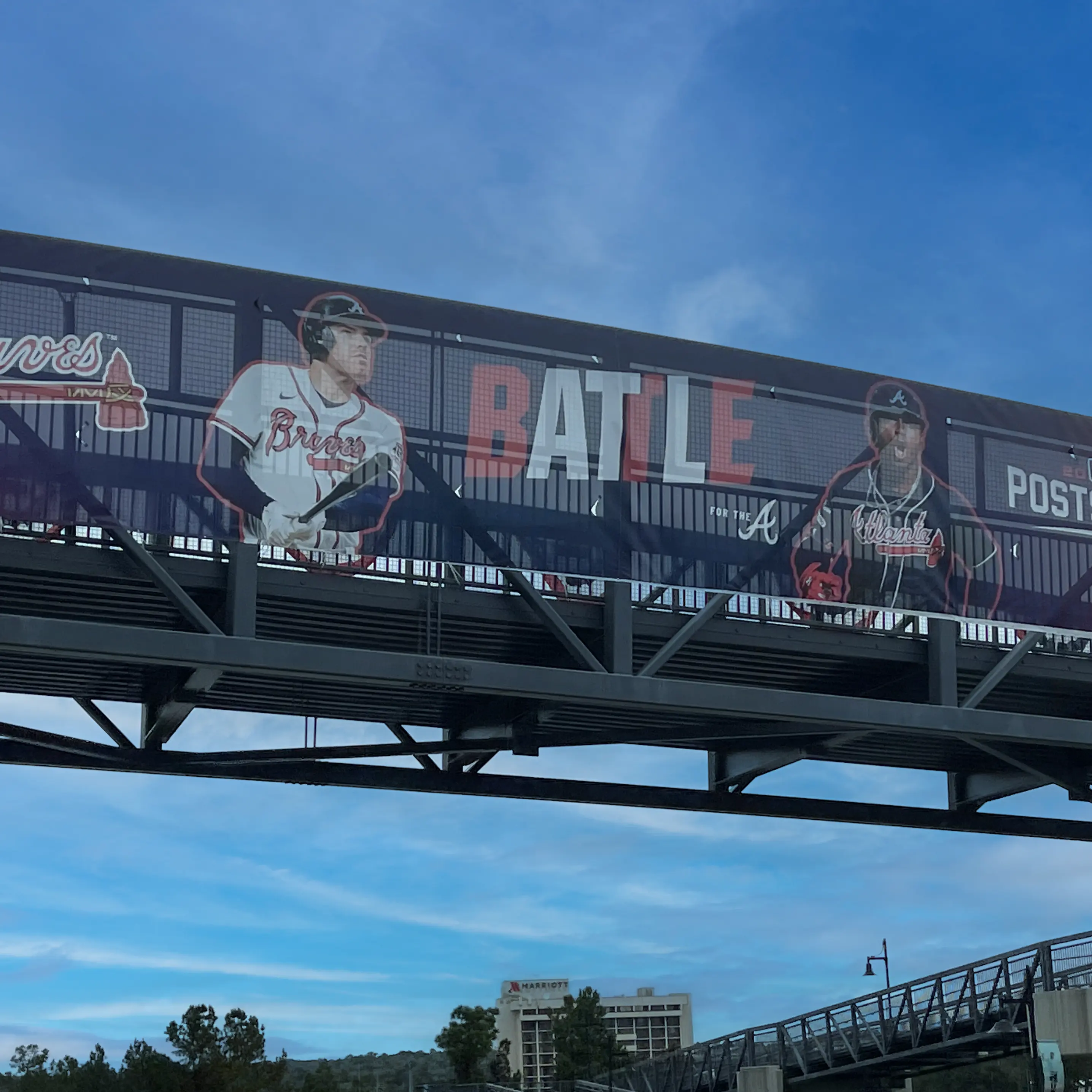 An image of a banner on a crosswalk above the road. 