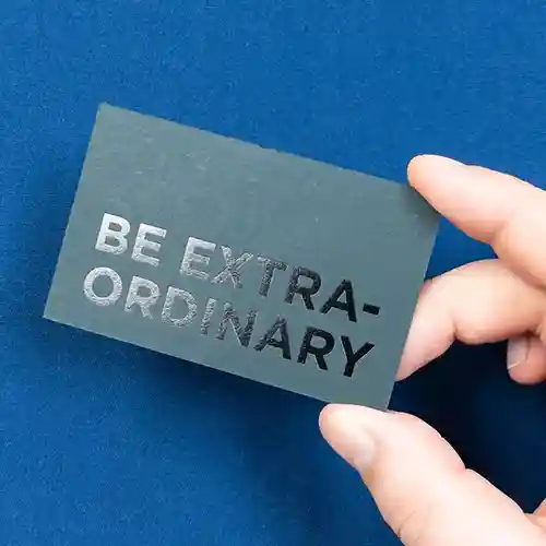 A photo of a business card with a glossy text finish.