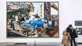 An image of a couple looking at a large print.