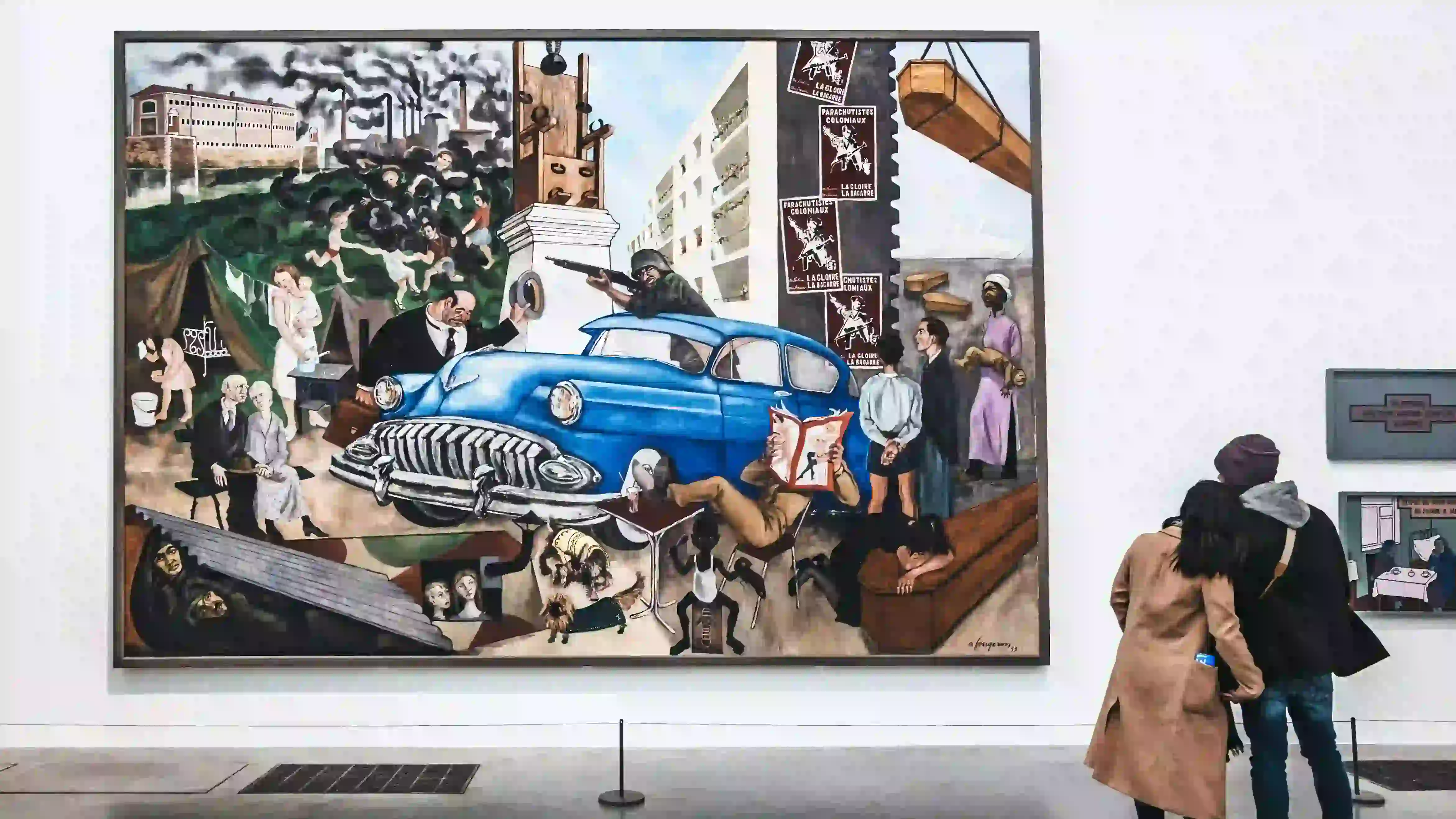 An image of a couple looking at a very large portrait.