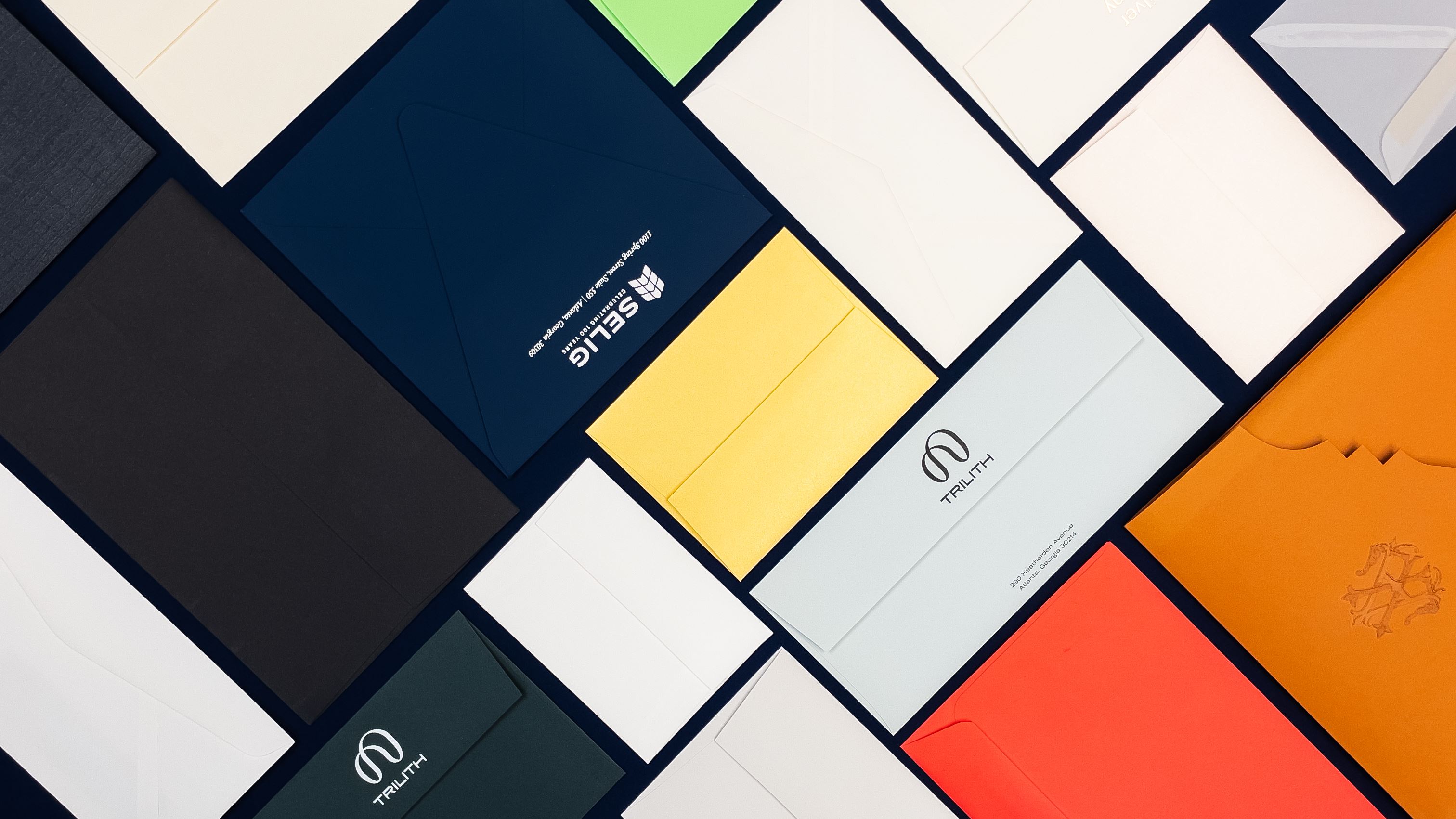 A collage of envelopes of various shapes, sizes, and colors