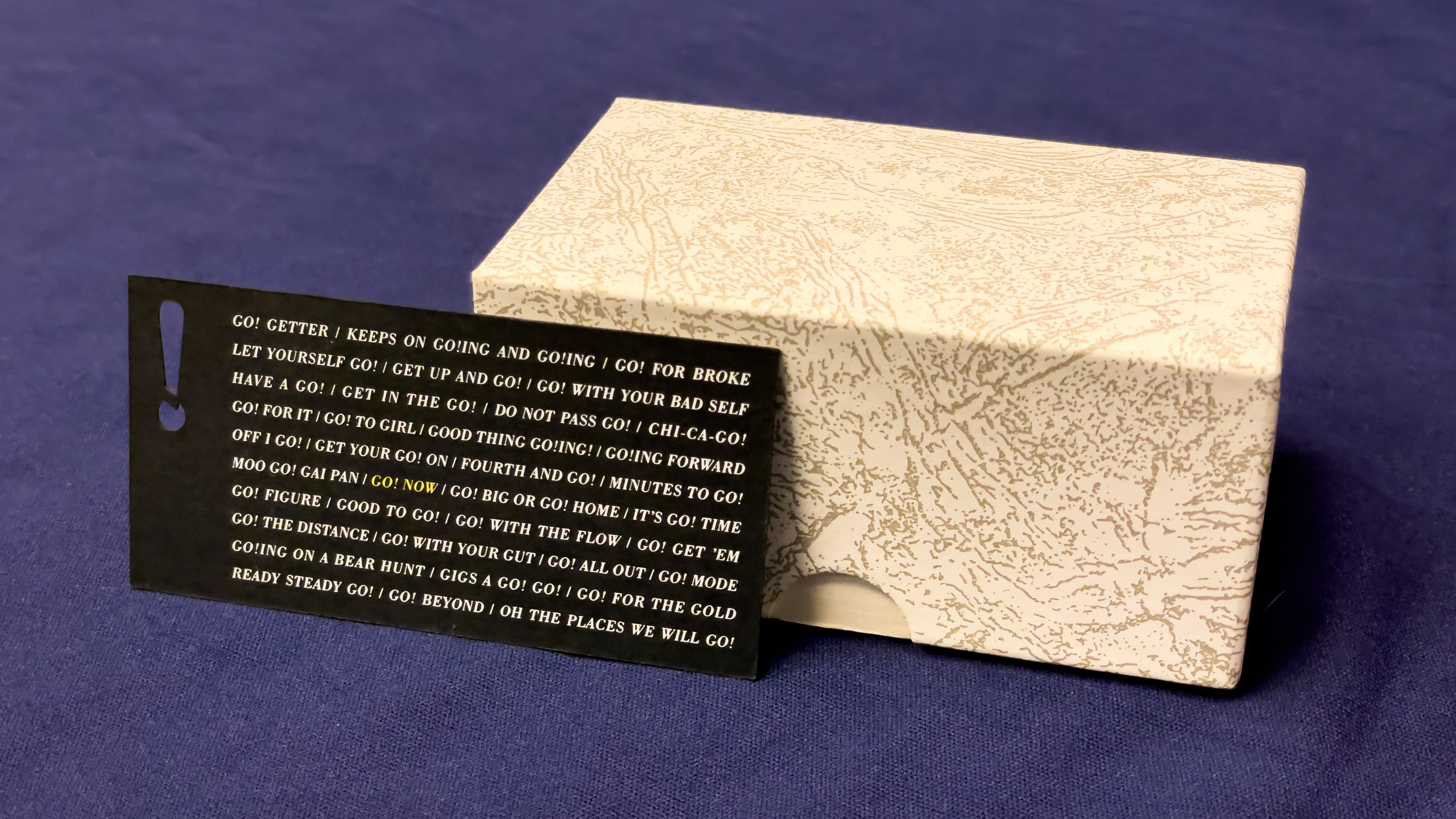 An image of a business card with an exclamation point cutout.