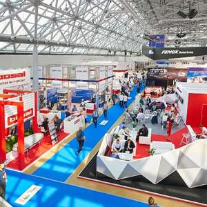 A busy trade show with elaborate booths