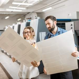 A woman looking at prints at a professional printing business