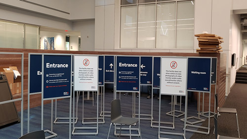 Stanchions with printed directional signage