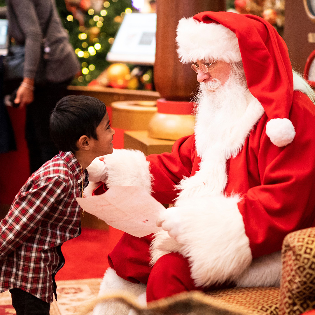Santa at a business talking with a child