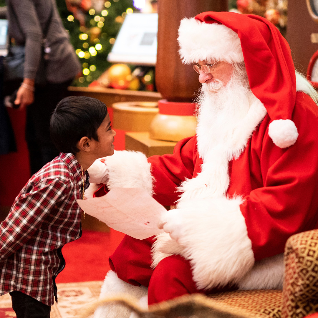 Santa at a business talking with a child