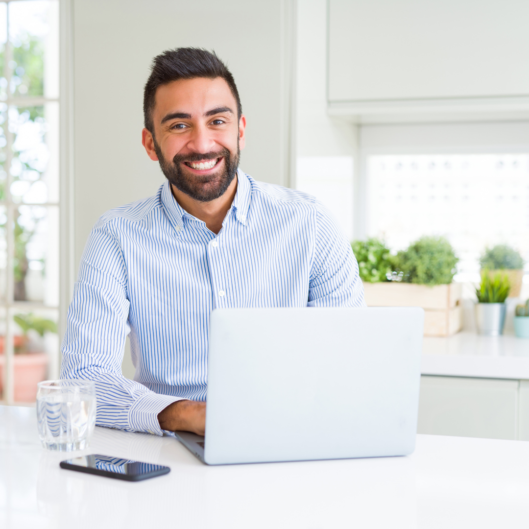 man smiling with laptop