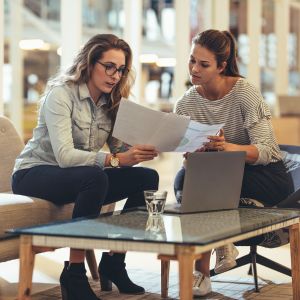 Two woman at a small business going over paperwork