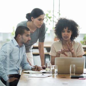 Three coworkers going over business analytics 