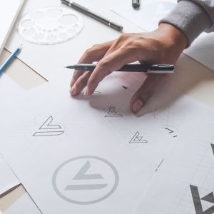 A designer looking over logo sketches