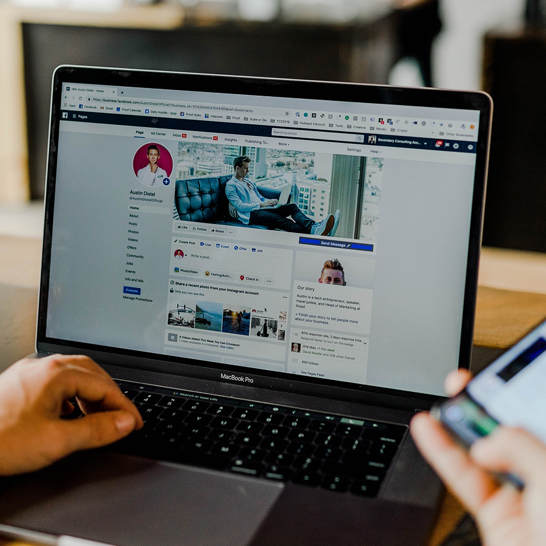 A social media profile on a laptop and phone