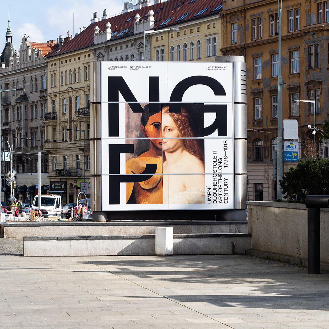 A poster for an art exhibit on a sign board on the street