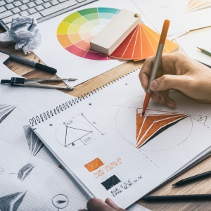 A designer sketching business logos