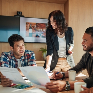 A group of creatives discussing new designs at a meeting