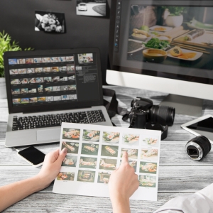 A designer looking through photographs on their computer
