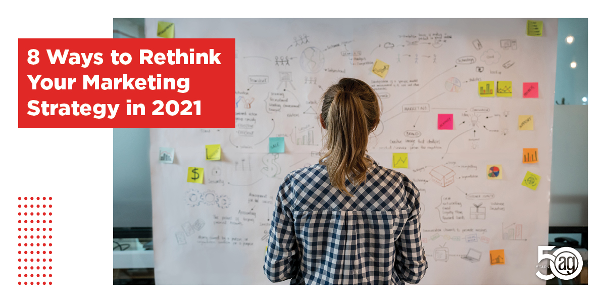 Woman looking at a white board with writing and post it notes on it