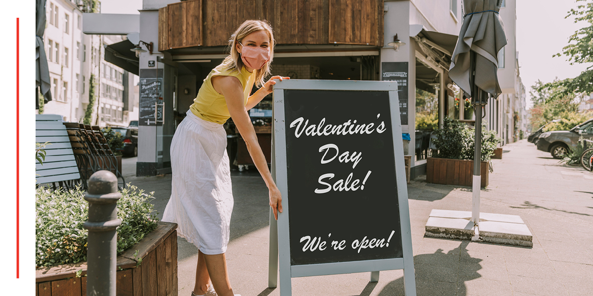 Woman outside holding a sign