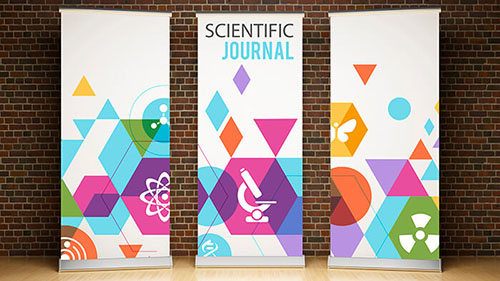 Three colorful pull-up banners against a brick wall