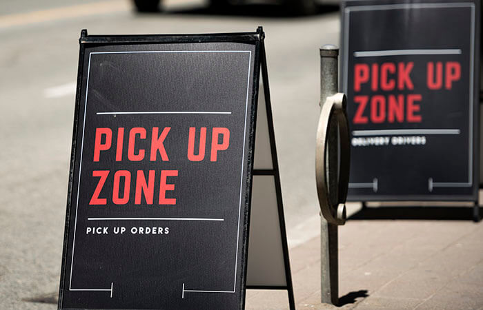 Wayfinding sign on the street directing to curbside pickup