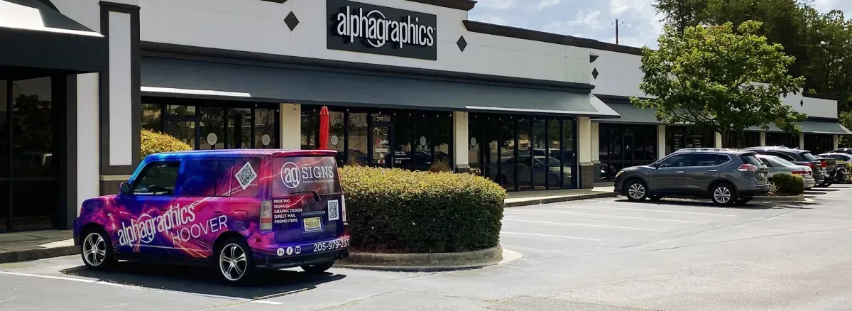 AlphaGraphics Hoover's purple and pink wrapped Scion xB parked outside the Hoover, AL print shop