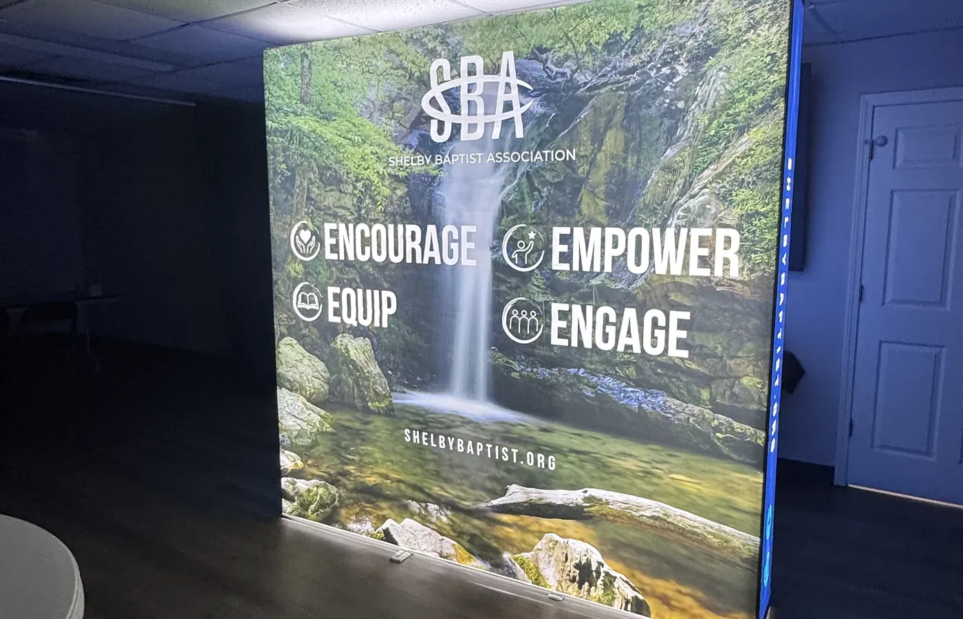 Custom backlit fabric display with a waterfall graphic for Shelby Baptist Association, printed by AlphaGraphics Hoover