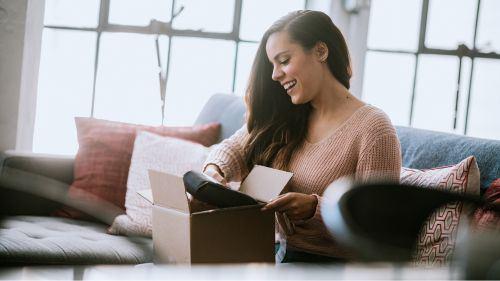 A woman opening a package at home