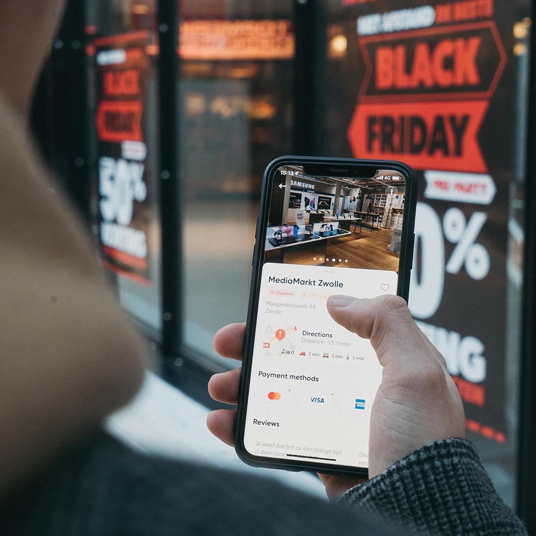 A person close to a business receiving promotions on their phone from that business
