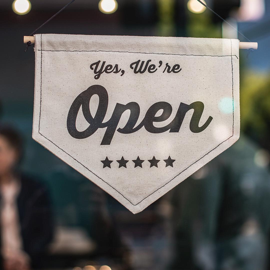 An open sign in the front of a small business
