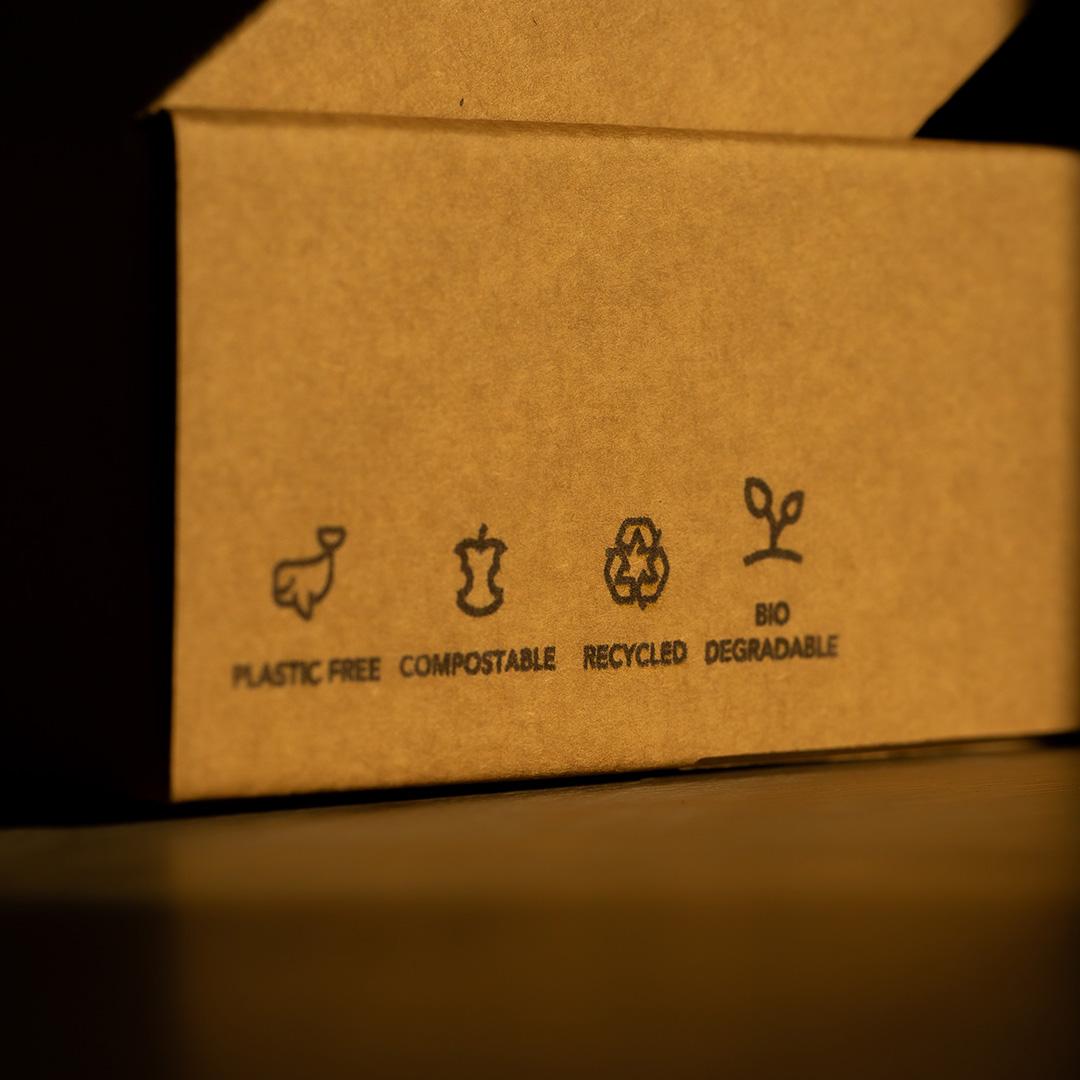 The side of a recycled paper box with icons on it