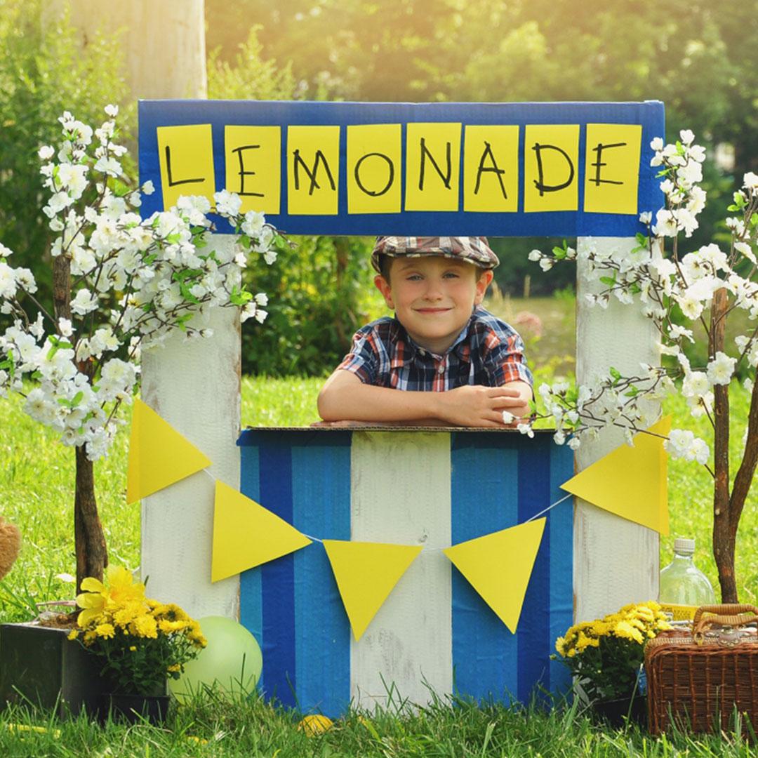 picture of boy selling lemonade at stand