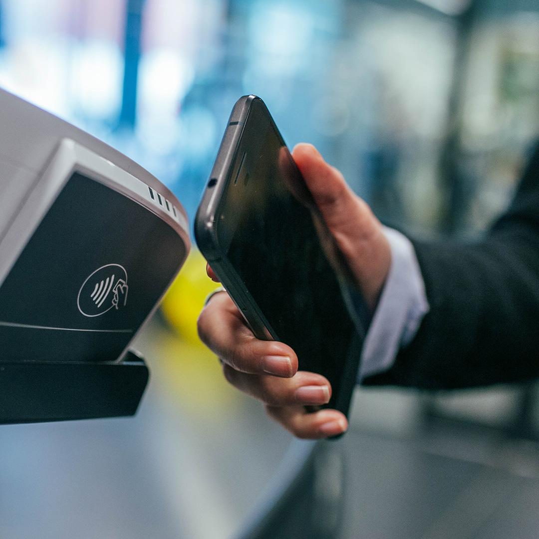 A person paying for something with a tap feature on their phone