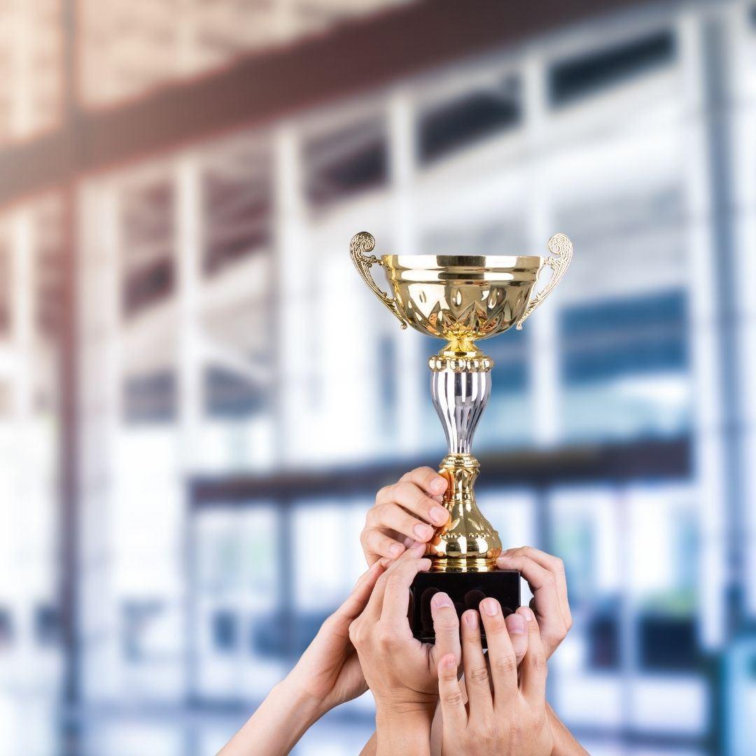 people holding up a trophy