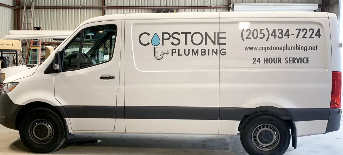 Capstone Plumbing white Sprinter van with logo, phone number and 24-hour service lettering