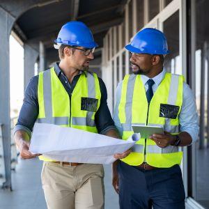 Construction workers looking at a blueprint on a job site