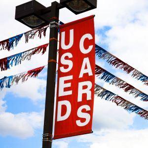 Vinyl sign at used car lot