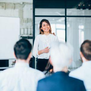 A businesswoman at a meeting holding a plaque