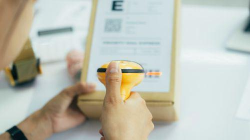 Person scanning a box barcode