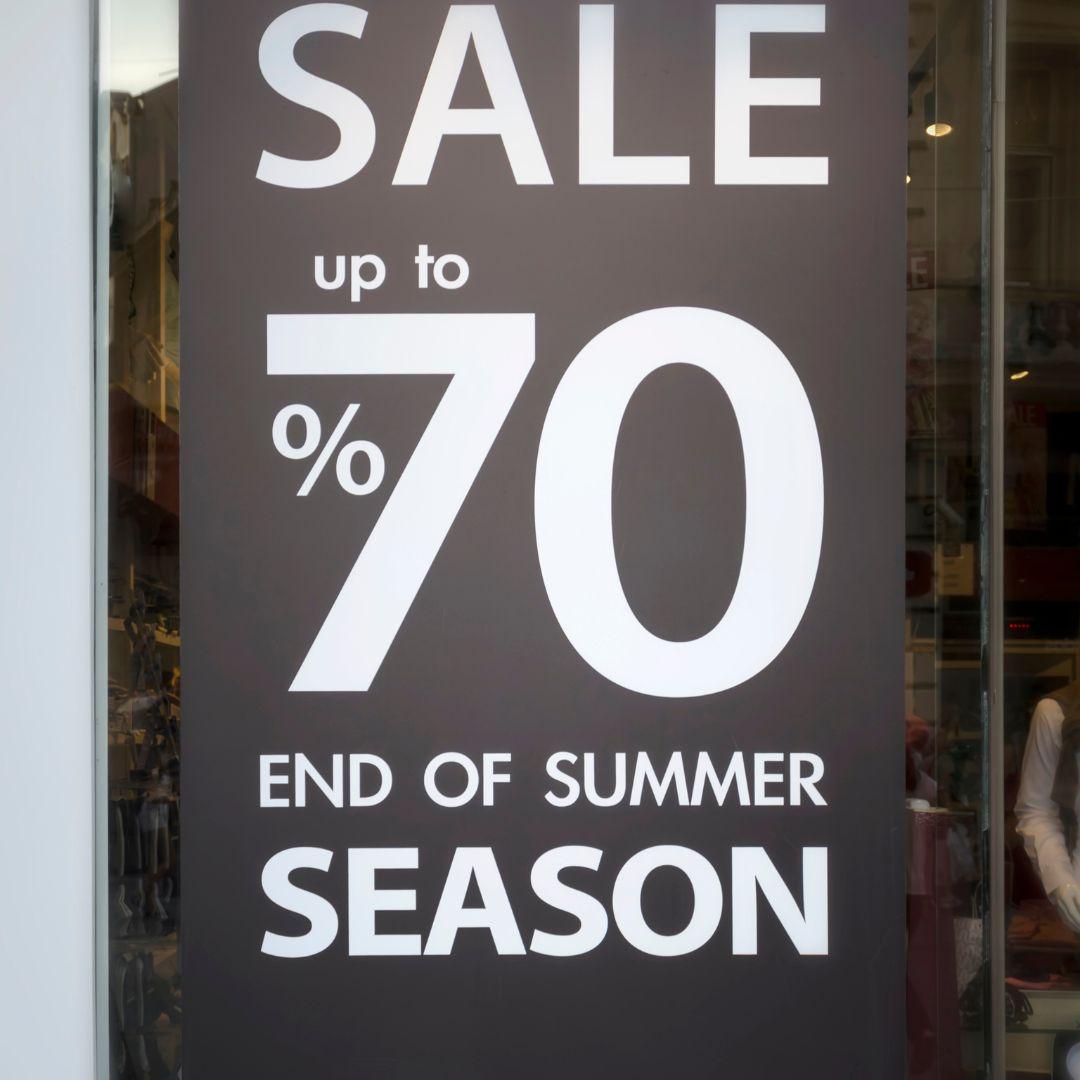 A sale poster in a storefront window