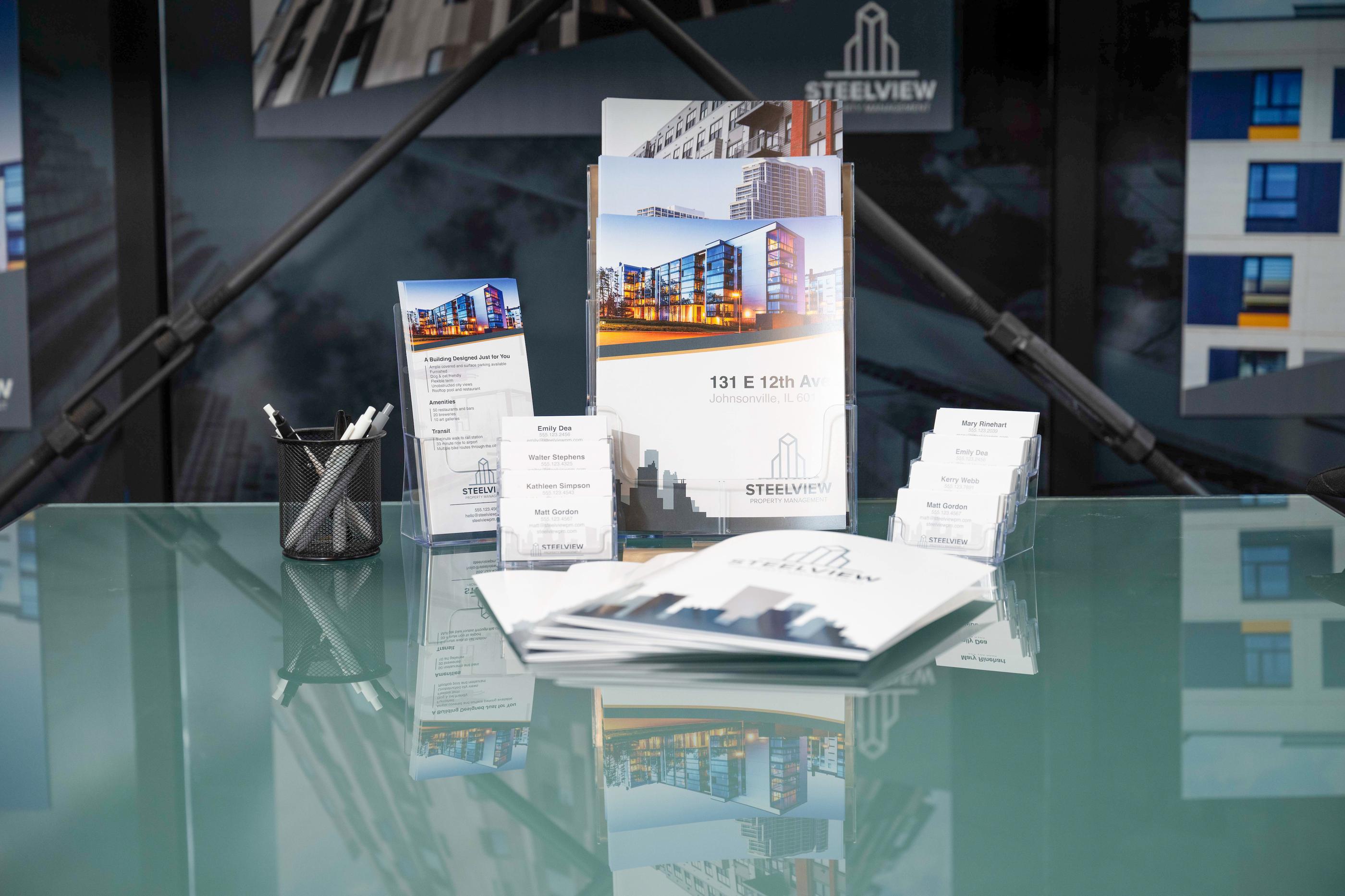 physical marketing materials on a glass table