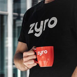 Person holding a branded coffee mug