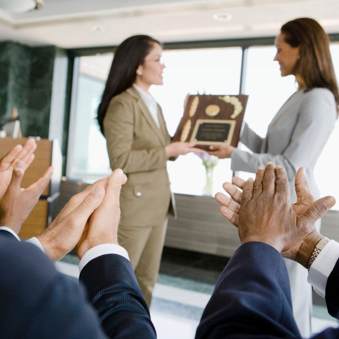 woman being awarded a plaque