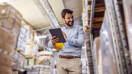 A warehouse shipping manager walking through the warehouse