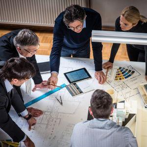 Architects looking at blueprints together